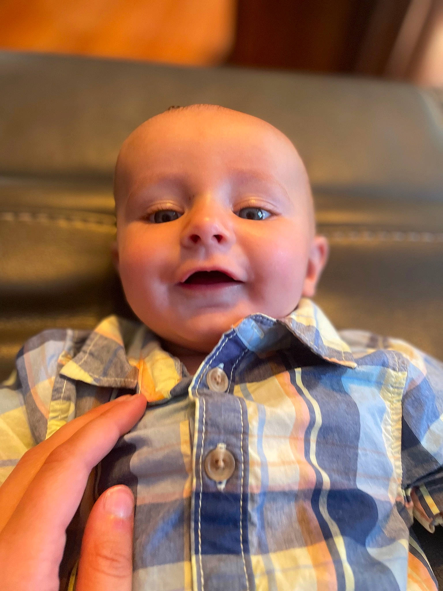 Colton is registered to the contest to win money with this photo: baby, cheek, chin, collar, dress_shirt, eye, finger, gesture, happy, iris, mouth, nose, person, plaid, skin, sleeve, smile, tartan, textile, thumb
