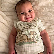 Marciano joined the competition — help win amazing prizes! baby, blanket, cartoon, child, clothing, cozy, cute, face, hand, happy, indoors, infant, legs, lying_down, onesie, portrait, skin, smiling, soft_texture, toddler