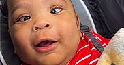Kaison joined the competition — help win amazing prizes! baby, child, stroller, red_shirt, striped_clothing, blanket, plush_toy, giraffe_toy, smiling, happy, face, expression, indoors, seatbelt, cute, infant, person, closeup, comfort, soft_toy
