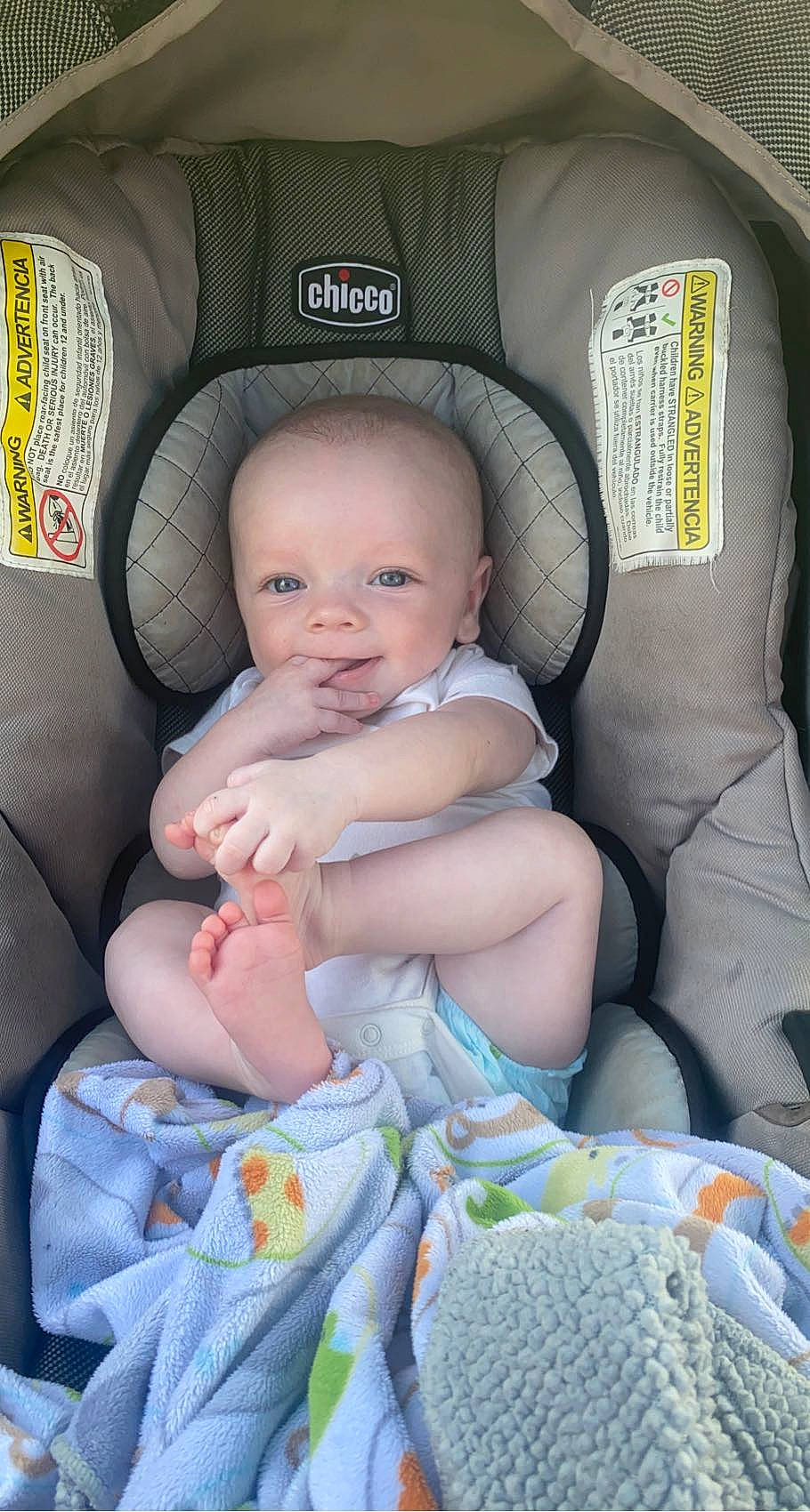 Daxton is registered to the contest to win money with this photo: auto_part, baby, baby_products, baby_toddler_clothing, car_seat, car_seat_cover, chair, child, comfort, finger, green, lap, linens, nail, person, product, sitting, skin, textile, toddler