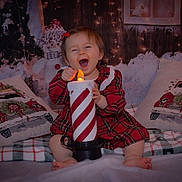 Esmée participe au concours pour gagner de l'argent avec cette photo : toddler, child, candle, plaid_dress, holiday_decor, christmas_pillows, snowman, festive_lights, winter_scene, indoor, cute, smiling, happy, decorative_candle, holiday_season, cozy, red_bow, cheerful, sitting, portrait