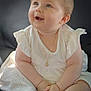 Esmée a rejoint le concours — aidez-le/la à gagner de superbes lots ! baby, child, white_dress, sitting, smile, happy, blue_eyes, bracelet, necklace, sock, cute, chubby, portrait, indoors, soft_light, couch, skin, short_hair, infant, hands