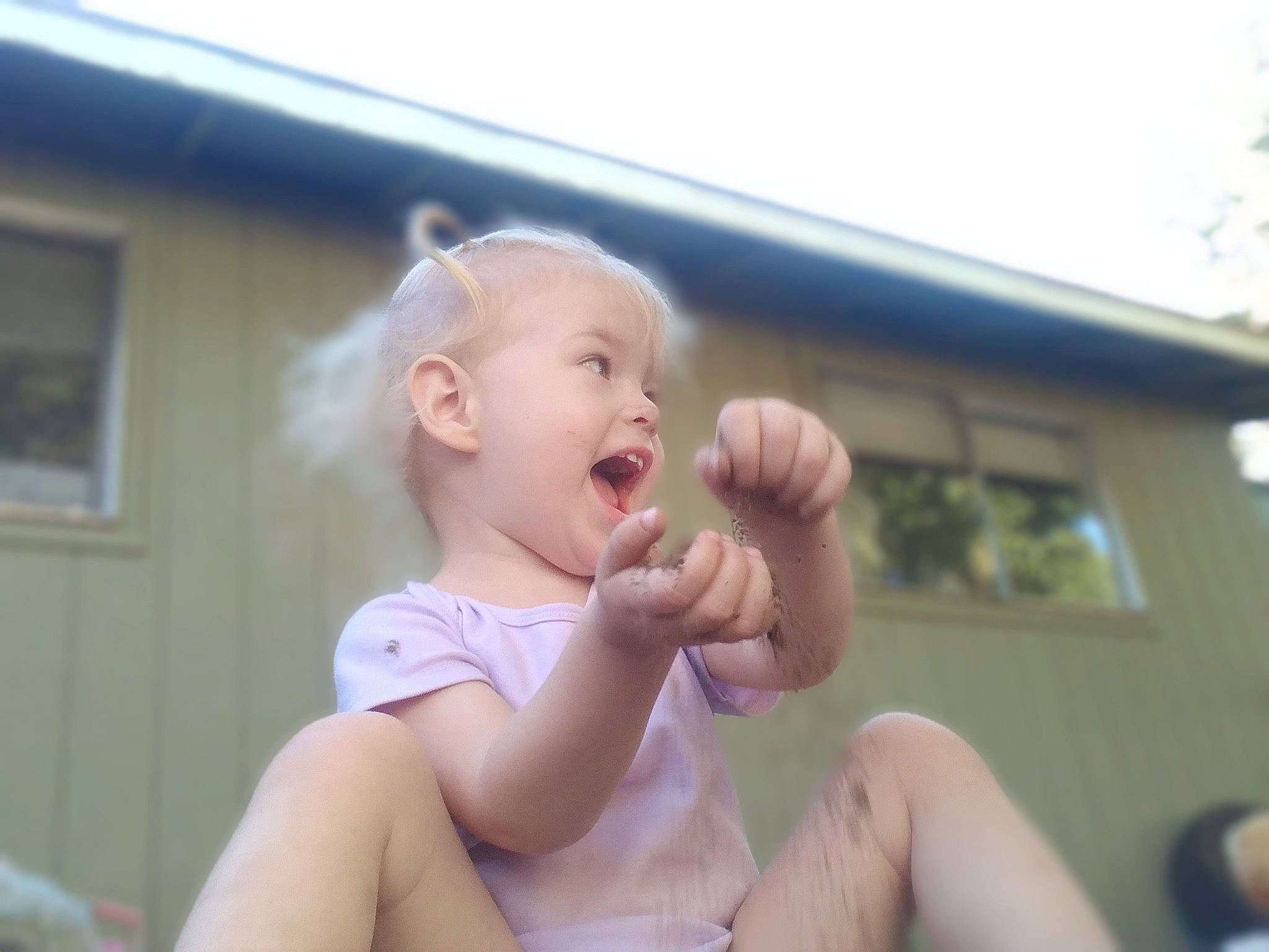 Araya joined the competition — help win amazing prizes! baby, baby_toddler_clothing, cheek, child, facial_expression, fun, gesture, grass, hand, happy, leisure, person, play, recreation, roof, sitting, sky, thumb, toddler, tree