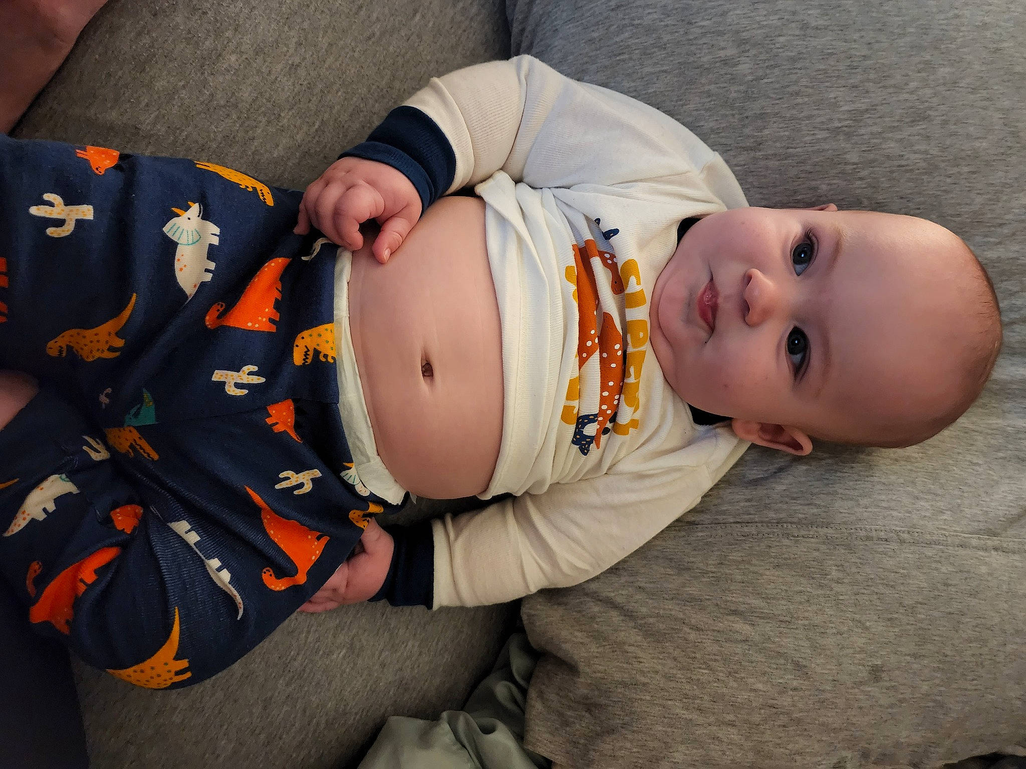 Casen is registered to the contest to win money with this photo: baby, baby_products, baby_toddler_clothing, child, comfort, dress, eye, glasses, grass, hat, headgear, human_body, leg, pattern, person, plant, sitting, sleeve, toddler, tree