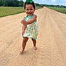 barefoot, child, cloudy_sky, cute, dirt_road, dress, field, grass, green_bow, happy, nature, outdoor, person, portrait, rural, smiling, summer, toddler, walking, young_child