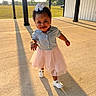 bow, building, child, concrete, daylight, grass, hair, happy, outdoor, person, pillar, portrait, shadow, shirt, smiling, sunlight, toddler, tutu_skirt, walking, white_shoes