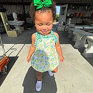 Kaizlee joined the competition — help win amazing prizes! child, toddler, smiling, green_bow, lemon_dress, white_shoes, shadow, sunlight, outdoor, stone_sculptures, workshop, garden_furniture, concrete_floor, curly_hair, closed_eyes, earrings, happy, portrait, walking, playful