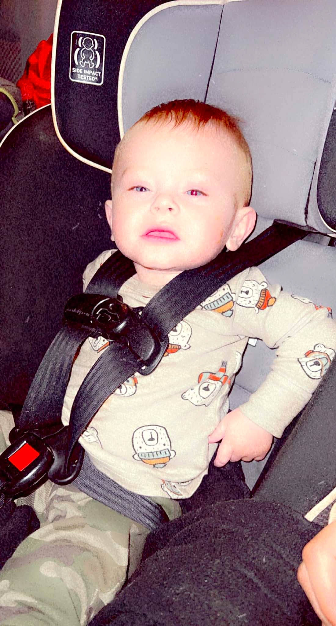 Jay is registered to the contest to win money with this photo: baby, baby_toddler_clothing, car_seat, cheek, chin, collar, comfort, cool, finger, hand, happy, head, neck, nose, person, product, seat_belt, skin, sleeve, smile