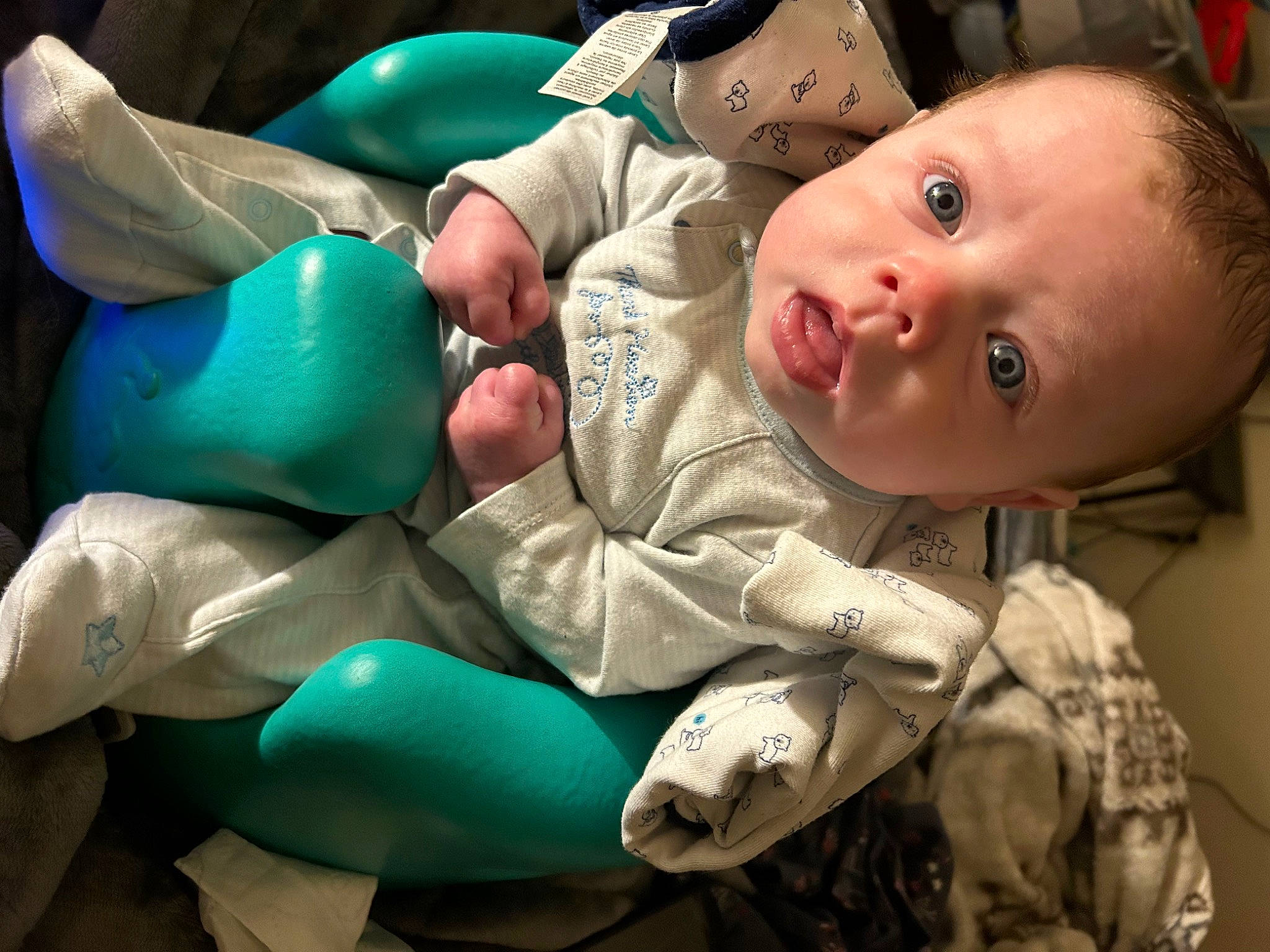 Chance is registered to the contest to win money with this photo: abdomen, baby, baby_products, baby_toddler_clothing, cheek, child, comfort, event, eye, facial_expression, finger, fun, happy, hat, human_body, linens, mouth, person, room, skin