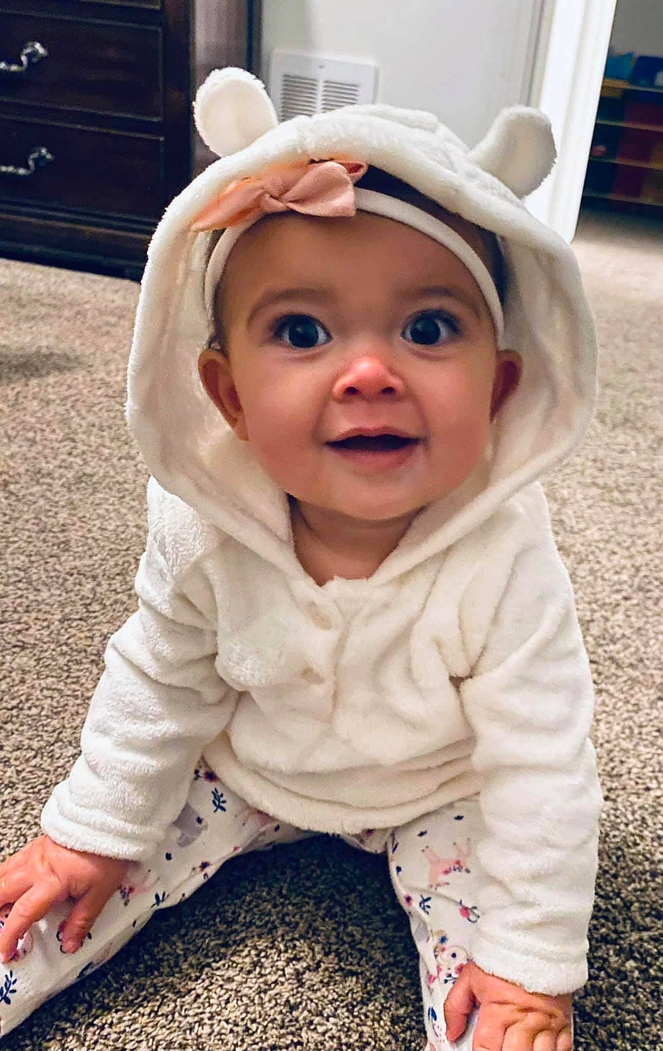 Laikyn is registered to the contest to win money with this photo: baby, baby_toddler_clothing, cheek, child, face, flooring, fun, grass, happy, headgear, headwear, iris, joy, lip, nose, pattern, person, sitting, skin, sleeve