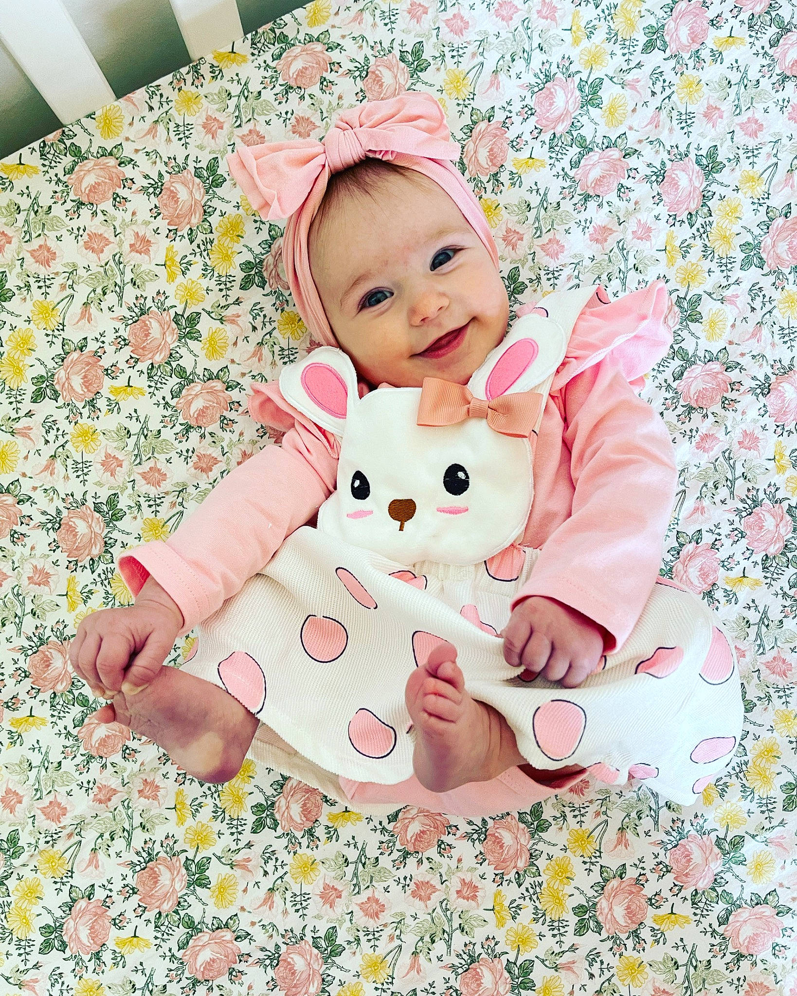 Olivia is registered to the contest to win money with this photo: baby, baby_toddler_clothing, bedding, child, comfort, flooring, foot, grass, happy, joy, linens, magenta, nightwear, pattern, person, pink, play, sitting, sleeve, smile