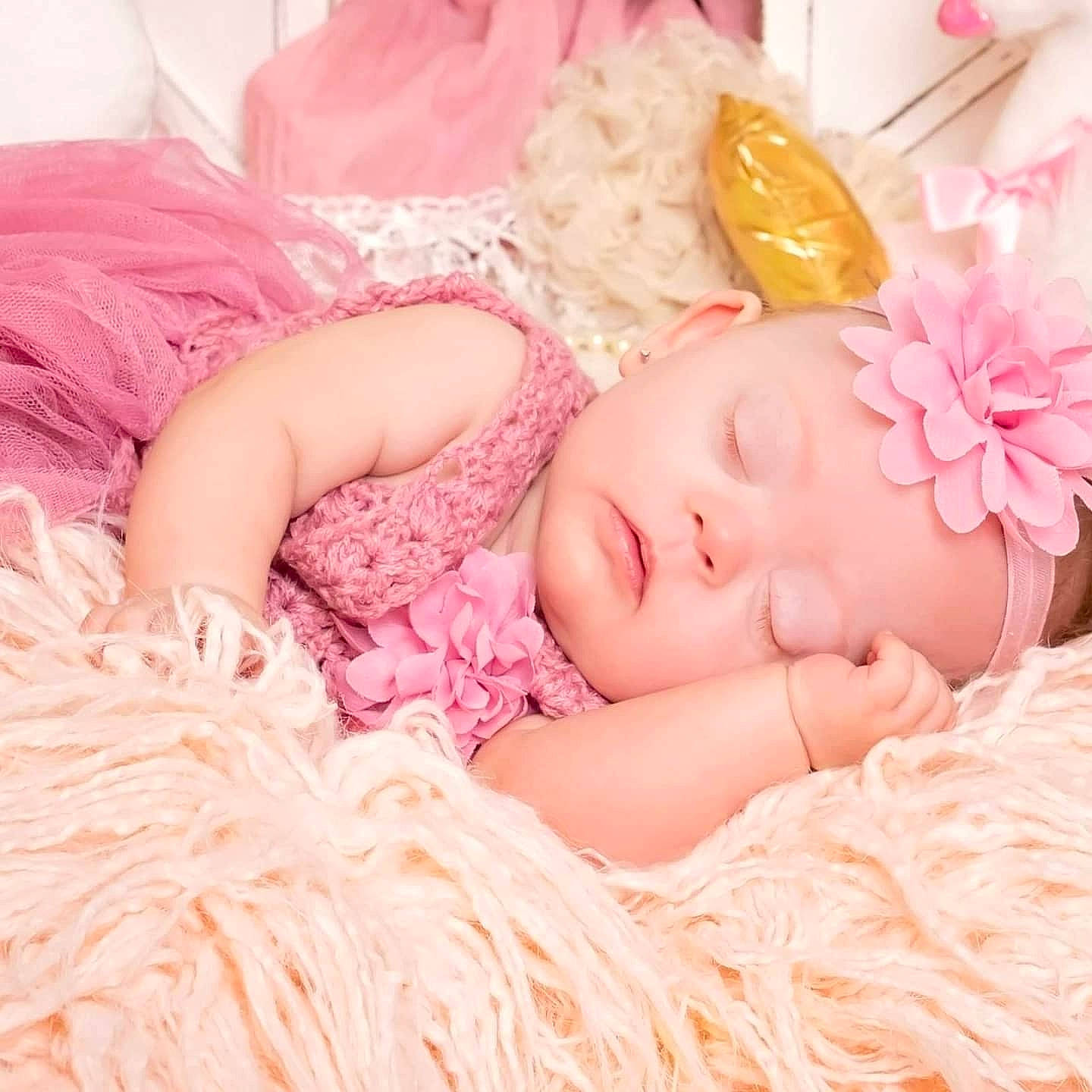 Saraya is registered to the contest to win money with this photo: arm, baby, baby_sleeping, baby_toddler_clothing, comfort, dress, eyelash, hat, head, headband, headgear, headpiece, headwear, iris, jewellery, linens, peach, person, pink, skin