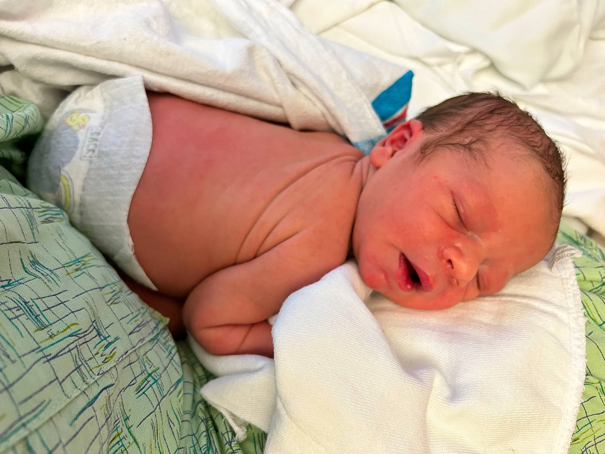 Clarence is registered to the contest to win money with this photo: abdomen, baby, baby_sleeping, baby_toddler_clothing, bedding, bedtime, child, comfort, grass, human, human_body, human_leg, linens, mammal, nap, person, room, skin, sleep, textile