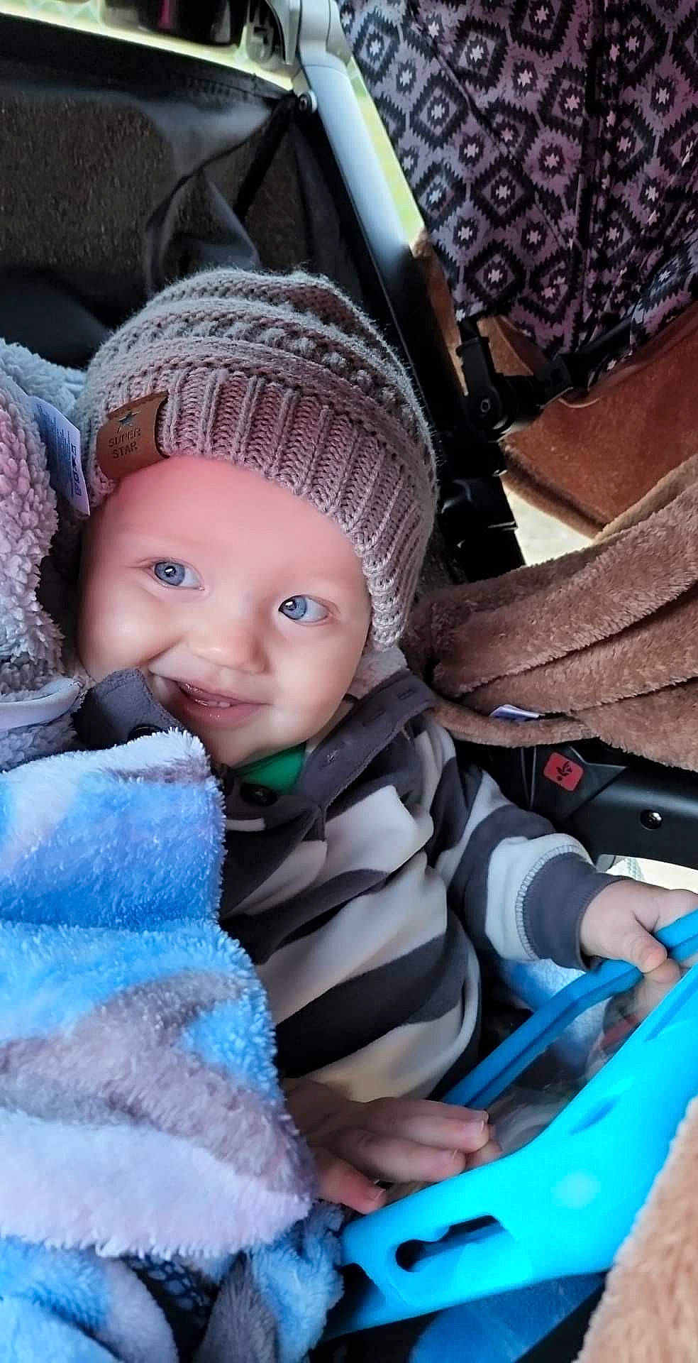 Adam joined the competition — help win amazing prizes! baby, baby_products, baby_toddler_clothing, blue, cap, cheek, child, comfort, electric_blue, fashion_accessory, fun, headwear, iris, knit_cap, person, purple, sitting, skin, toddler, winter
