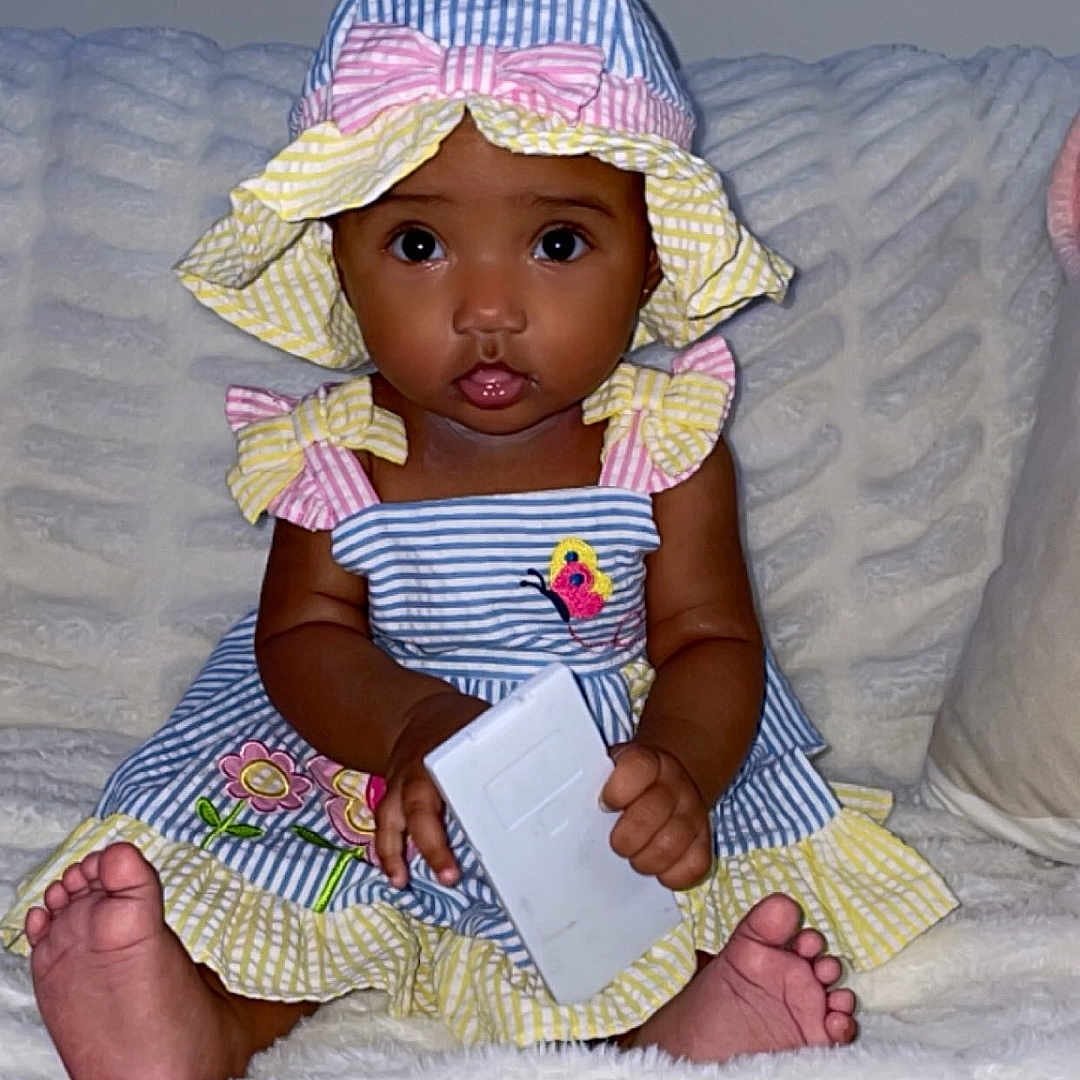 Sivelis joined the competition — help win amazing prizes! baby, bed, bonnet, cap, clothing, couch, cushion, doll, face, furniture, hat, head, homedecor, person, photography, portrait, reading, sitting, sunhat, toy
