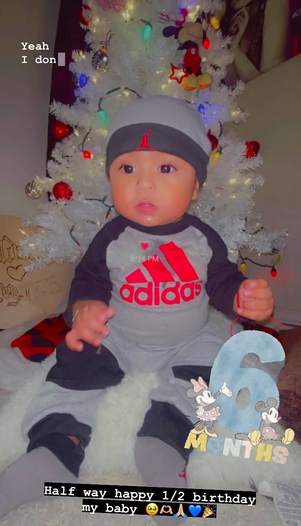 Edward is registered to the contest to win money with this photo: baby_toddler_clothing, carmine, child, christmas, christmas_decoration, christmas_eve, christmas_ornament, christmas_tree, costume_hat, event, headwear, holiday, holiday_ornament, ornament, party_supply, person, pink, product, sleeve, surprise