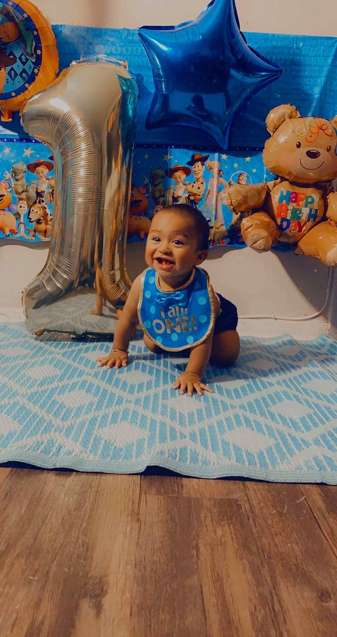 Edward joined the competition — help win amazing prizes! baby, baby_toddler_clothing, blue, chair, child, event, floor, flooring, fun, happy, hardwood, leisure, pattern, person, sitting, smile, t_shirt, teddy_bear, toddler, wood