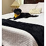 dog, small_dog, black_dog, yellow_bandana, pet, animal, bed, bedroom, white_bedding, black_blanket, pillow, headboard, lamp, window, curtains, indoor, home, relaxing, phone_screenshot, gallery_interface