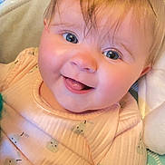 Gracie-Mae is registered to the contest to win money with this photo: baby, child, face, smile, tongue, clothing, peach, pattern, pear, infant, cute, happy, skin, hair, eyes, indoors, soft, blanket, portrait, person