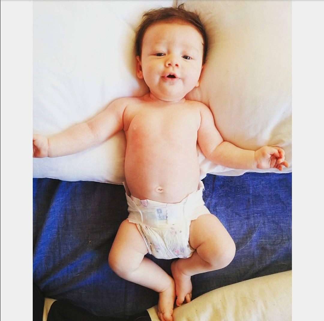 Brooke participe au concours pour gagner de l'argent avec cette photo : arm, baby, child, diaper, gesture, leg, person, photography, portrait, product, sitting, toddler