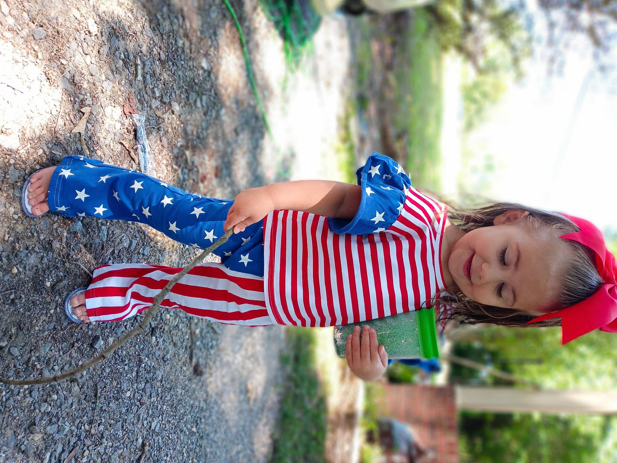 Everleigh is registered to the contest to win money with this photo: dress, electric_blue, flag, flag_of_the_united_states, fun, grass, happy, human_leg, knee, leisure, pattern, people_in_nature, person, plant, recreation, red, street_fashion, thigh, tree, trunk