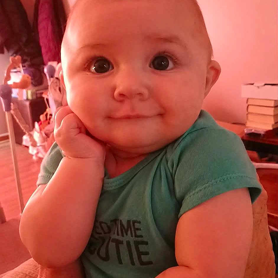 Ryder joined the competition — help win amazing prizes! baby, child, indoor, person, face, smile, cute, arm, hand, shirt, green_shirt, skin, expression, portrait, young, infant, human, head, eyes, cozy