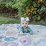 Athena is registered to the contest to win money with this photo: baby, bow, child, clothing, cute, grass, greenery, happy, head, headband, infant, nature, outdoor, patchwork, person, playful, quilt, smiling, toddler, tongue_out