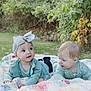 autumn_leaves, babies, baby, blanket, child, curious, cute, grass, greenery, headband, infant, lying_down, nature, outdoor, portrait, quilt, smiling, soft_light, sparkly_bow, two_children