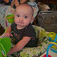 Athena joined the competition — help win amazing prizes! baby, child, infant, activity_center, toy, gaming_device, boy, indoor, furniture, couch, blanket, person, play, expression, face, sitting, curious, home, casual, relaxing
