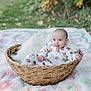 Athena joined the competition — help win amazing prizes! baby, basket, blanket, child, clothing, cute, grass, greenery, head, infant, natural_light, outdoor, patterned_pajamas, portrait, quilt, relaxed, sitting, smiling, soft_texture, tongue_out