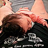 baby, pacifier, sleeping, curly_hair, person, clothing, bed, blanket, tattoo, legs, home, casual, relaxation, indoor, comfort, black_shirt, orange_clothing, closeup, rest, nap