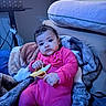 Jimma is registered to the contest to win money with this photo: baby, child, pink_onesie, toy_banana, blanket, cozy, indoor, curly_hair, cute, portrait, infant, soft_texture, sitting, home, furniture, relaxed, expression, warm_clothing, playful, young