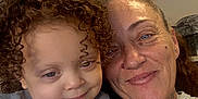 Luna is registered to the contest to win money with this photo: child, toddler, woman, curly_hair, smile, indoor, portrait, face, person, close_up, candid, family, happy, casual_clothing, skin, head_and_shoulders, together, bonding, human, affection
