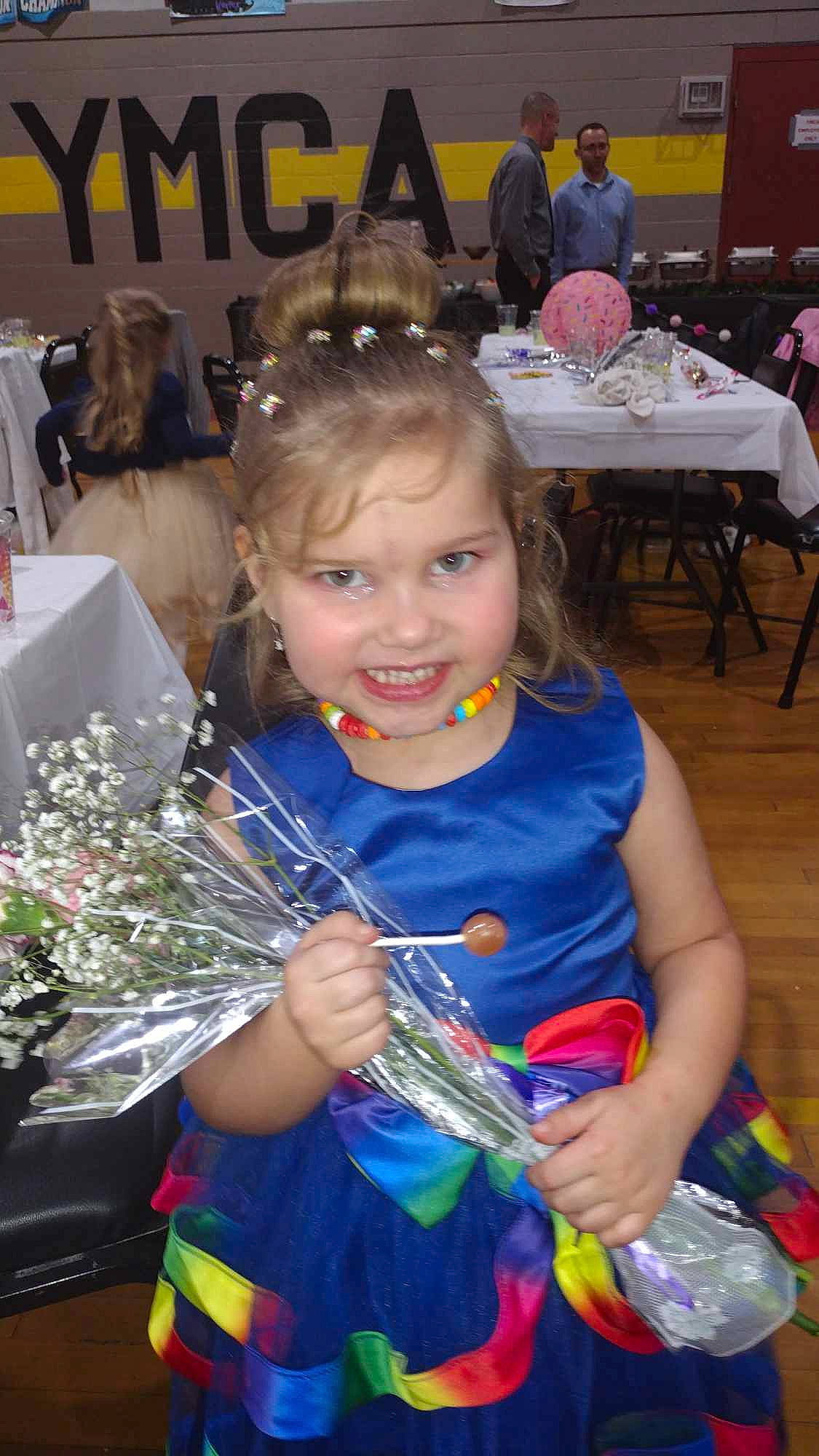 Amelia joined the competition — help win amazing prizes! chair, cheerleading_uniform, child, costume, electric_blue, event, floral_design, flower_arranging, fun, happy, holiday, jewellery, joy, party, person, plant, recreation, sitting, smile, t_shirt