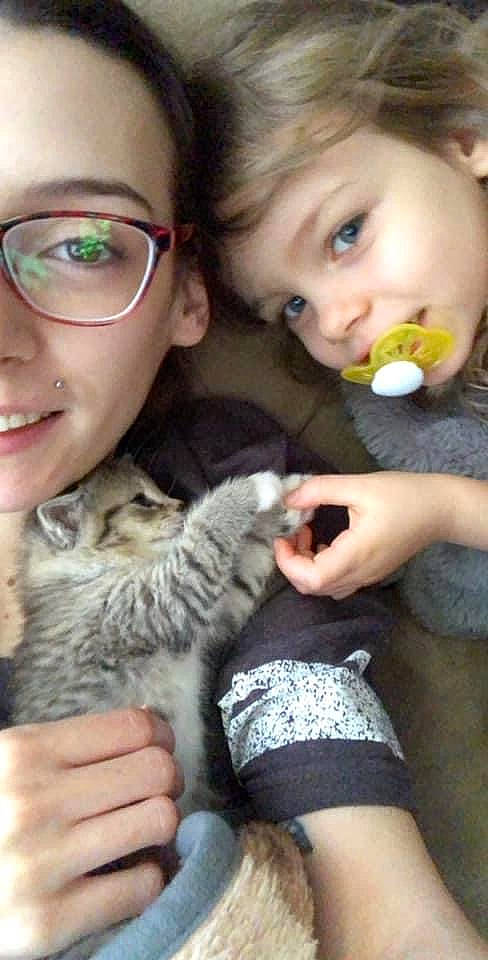 Natalee is registered to the contest to win money with this photo: carnivore, cat, eye, eyewear, face, fawn, felidae, finger, gesture, glasses, hand, happy, interaction, iris, nose, organ, person, skin, small_to_medium_sized_cats, vision_care