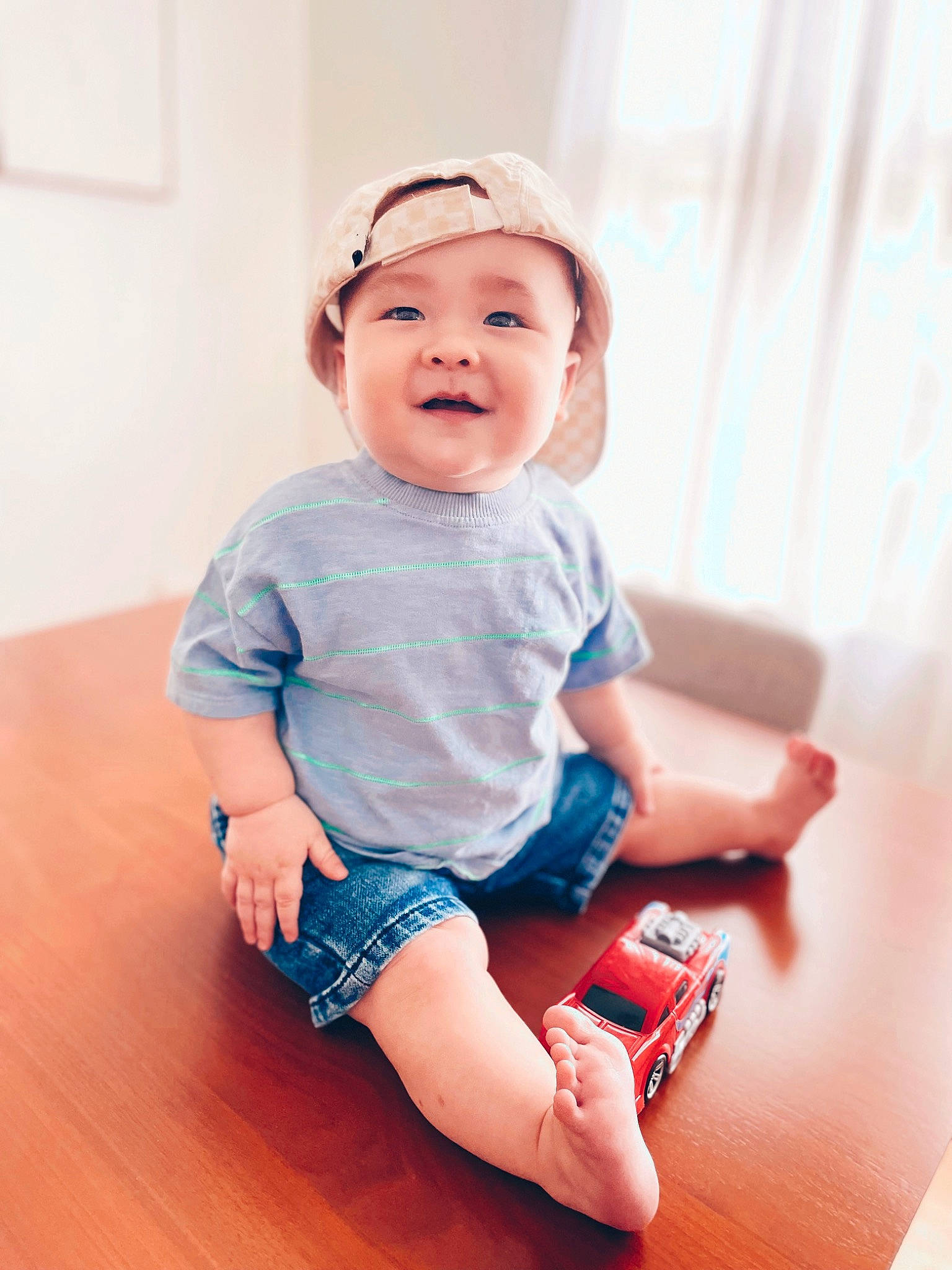 Deegan joined the competition — help win amazing prizes! baby, baby_toddler_clothing, child, elbow, electric_blue, finger, flash_photography, flooring, happy, hardwood, headwear, human_leg, knee, pattern, person, sitting, skin, sleeve, smile, thigh