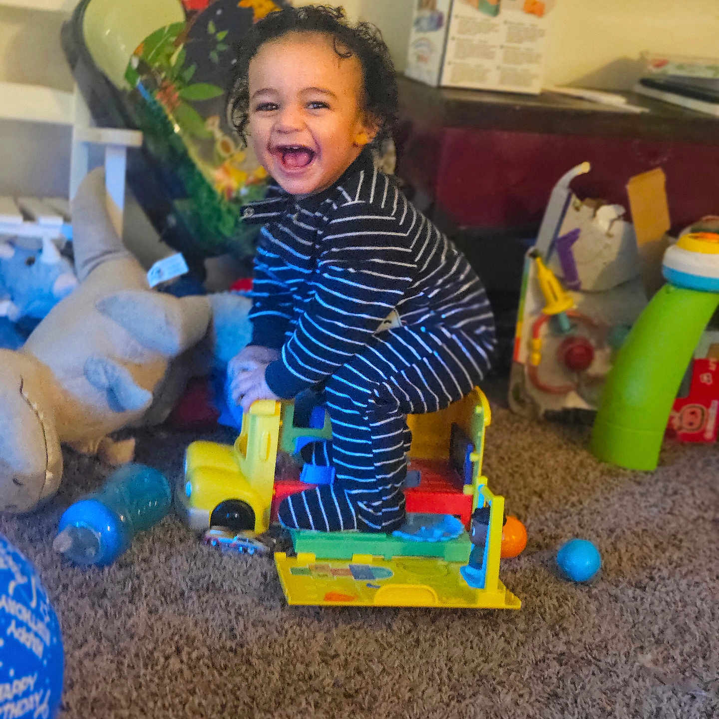Hezekiah is registered to the contest to win money with this photo: architecture, baby, ball, building, couch, face, football, furniture, happy, head, indoors, laughing, livingroom, person, photography, playarea, portrait, room, sphere, toy