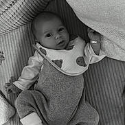 Sergio participe au concours pour gagner de l'argent avec cette photo : baby, infant, blanket, pillow, bib, knitted_clothing, socks, face, person, cute, indoor, laying_down, looking_at_camera, soft_texture, monochrome, cozy, sleepwear, newborn, child, portrait