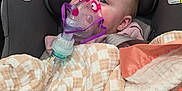 Zoey joined the competition — help win amazing prizes! baby, blanket, car_interior, car_seat, chicco_logo, child, eyes, face, healthcare, infant, medical, nebulizer_mask, oxygen_mask, pacifier, pink_mask, portrait, seatbelt, sitting, soft_fabric, warning_label
