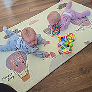 Chloe joined the competition — help win amazing prizes! baby, babies, play_mat, toy, floor, wood_floor, indoor, child, infant, clothing, pink_outfit, blue_outfit, toddler_legs, colorful_toy, playtime, cute, head, hands, crawling, floor_mat