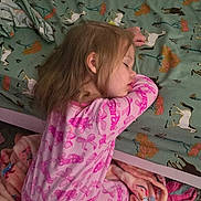 Alaina is registered to the contest to win money with this photo: child, sleeping, pajamas, pink, blanket, bed, bedspread, horse_pattern, carpet, indoor, young_child, girl, resting, cozy, furniture, home, nap, curly_hair, peaceful, room