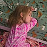 bed, bedspread, blanket, carpet, child, cozy, curly_hair, furniture, girl, home, horse_pattern, indoor, nap, pajamas, peaceful, pink, resting, room, sleeping, young_child