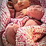 baby, newborn, sleeping, pink_clothing, blanket, knitted_blanket, cozy, soft_texture, infant, cute, peaceful, wrapped, hands, face, portrait, indoor, warm, resting, child, toddler