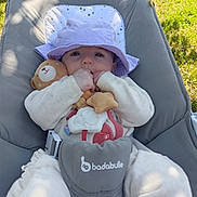 Mya participe au concours pour gagner de l'argent avec cette photo : baby, purple_hat, teddy_bear, plush_toy, baby_chair, outdoor, grass, sunlight, infant, cute, child, soft_toys, blanket, smiling, person, nature, daylight, relaxing, comfort, clothing