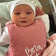 Albane participe au concours pour gagner de l'argent avec cette photo : newborn, baby, infant, pink_blanket, hat, hospital, bassinet, sleeping_bag, face, hands, cute, cozy, child, person, portrait, wrapped, soft_texture, bed, white_clothing, resting