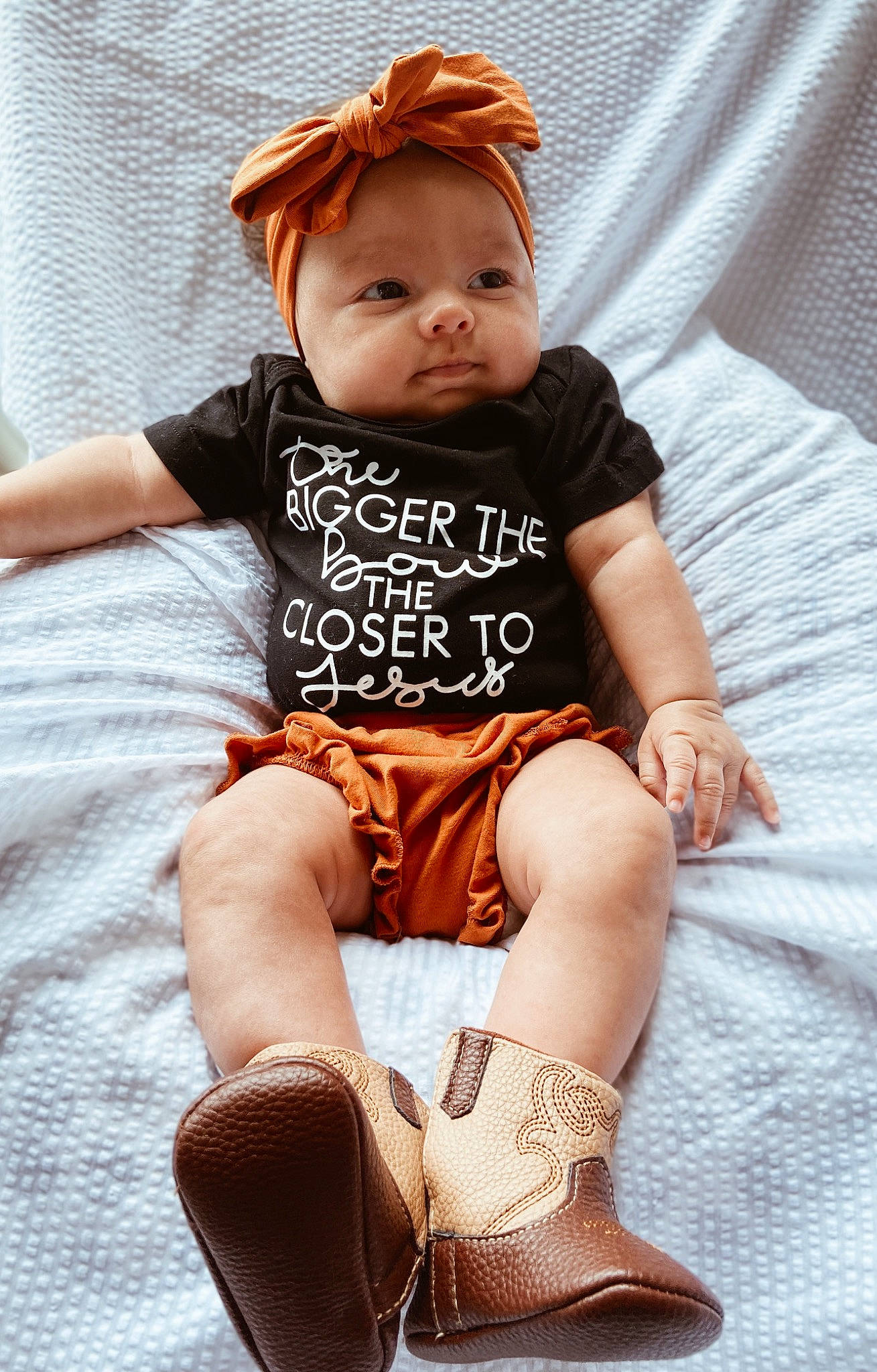 Bristol is registered to the contest to win money with this photo: arm, baby_toddler_clothing, chair, face, fashion, fawn, hand, head, joint, knee, leg, neck, pattern, person, pink, skin, sleeve, sock, textile, thigh