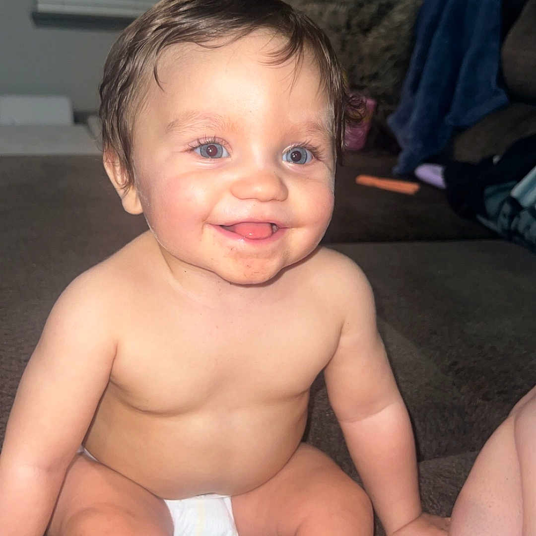 Anthony is registered to the contest to win money with this photo: baby, bodypart, couch, diaper, face, finger, furniture, hand, happy, head, homedecor, indoors, laughing, mouth, person, photography, portrait, sitting, smile, teeth