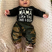 Lauren joined the competition — help win amazing prizes! baby, smiling, infant, clothing, black_shirt, text, camo_pants, booties, blanket, soft_texture, happy, cute, lying_down, indoor, child, portrait, small_hands, cheerful, infant_fashion, cozy