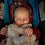 Lauren is registered to the contest to win money with this photo: baby, sleeping, stuffed_animal, car_seat, hood, floral_pattern, hand, infant, child, cozy, soft_toy, blanket, clothing, seatbelt, warning_label, cute, peaceful, portrait, indoor, closeup