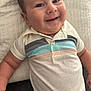 baby, child, smiling, portrait, polo_shirt, striped_clothing, chubby_cheeks, happy, cute, infant, lying_down, soft_texture, quilt, closeup, human, skin, arm, head, face, casual_clothing